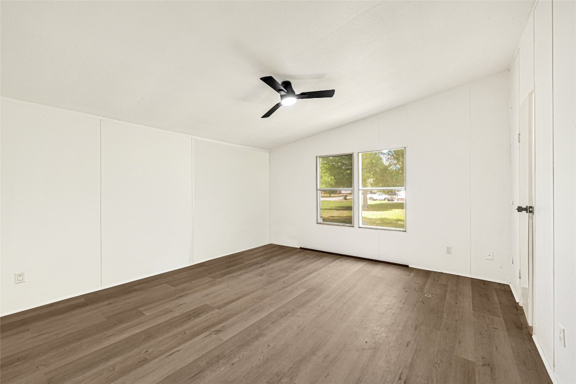 16315 Lone Star Ranch Drive Conroe, TX 77302 - Photo 18 of 20 an empty room with wooden floor and windows
