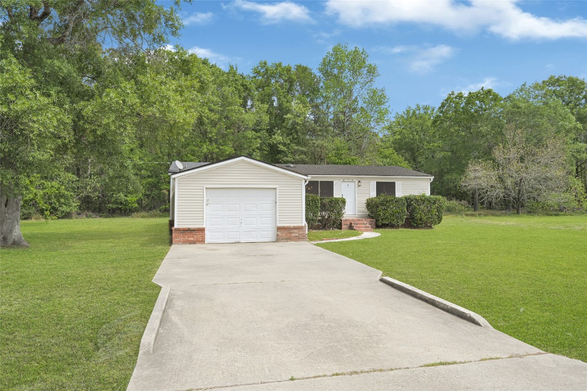 16315 Lone Star Ranch Drive Conroe, TX 77302 - Photo 2 of 20 a front view of a house with yard