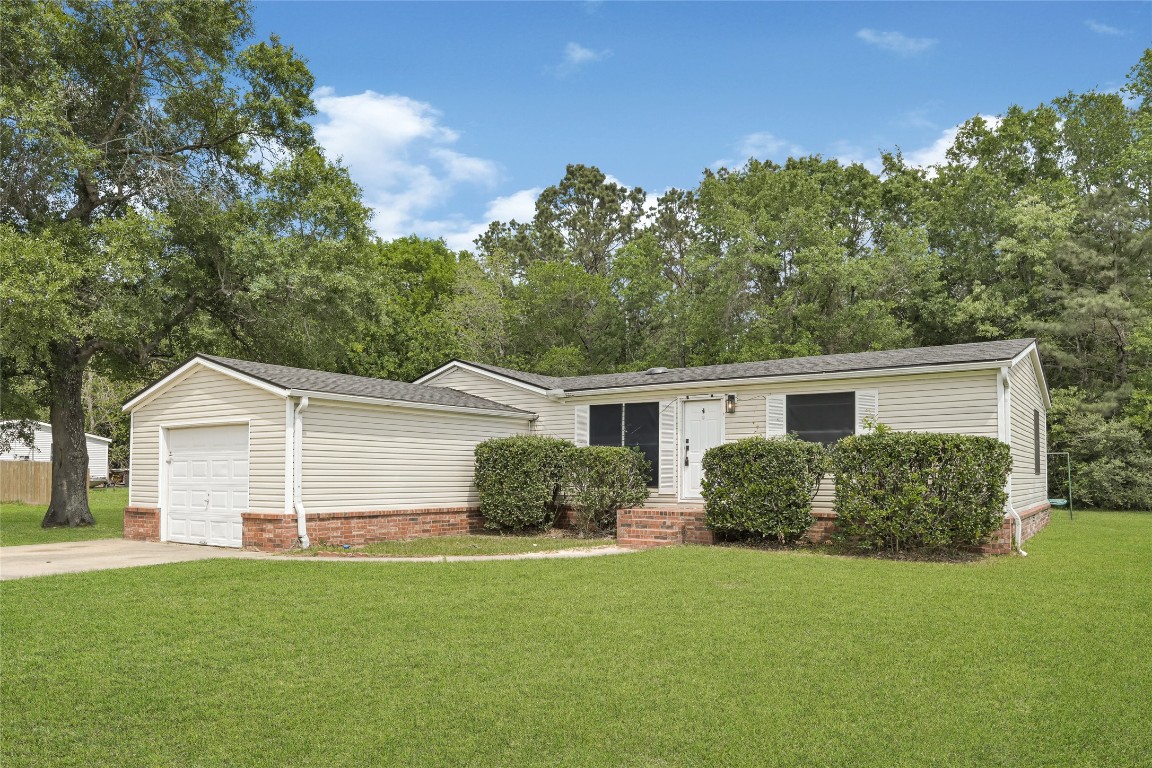 16315 Lone Star Ranch Drive Conroe, TX 77302 - Photo 3 of 20 front view of a house with a yard