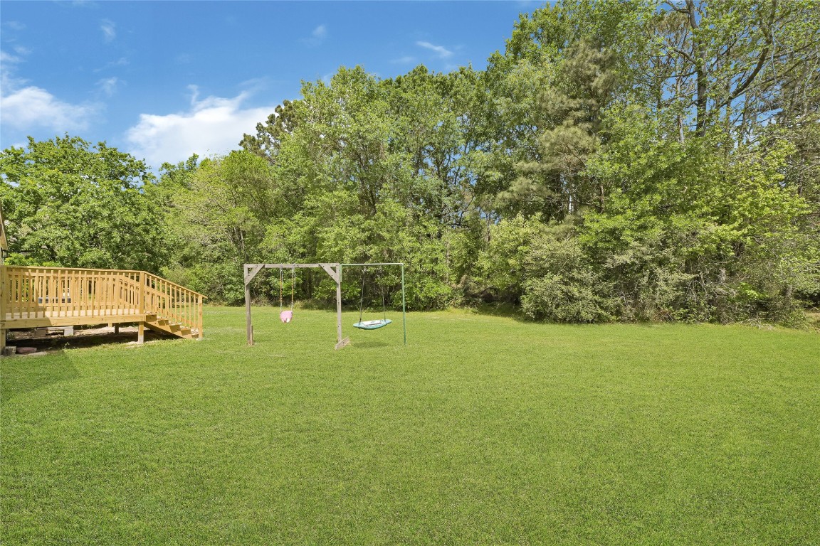 16315 Lone Star Ranch Drive Conroe, TX 77302 - Photo 4 of 20 a view of a field of grass and trees