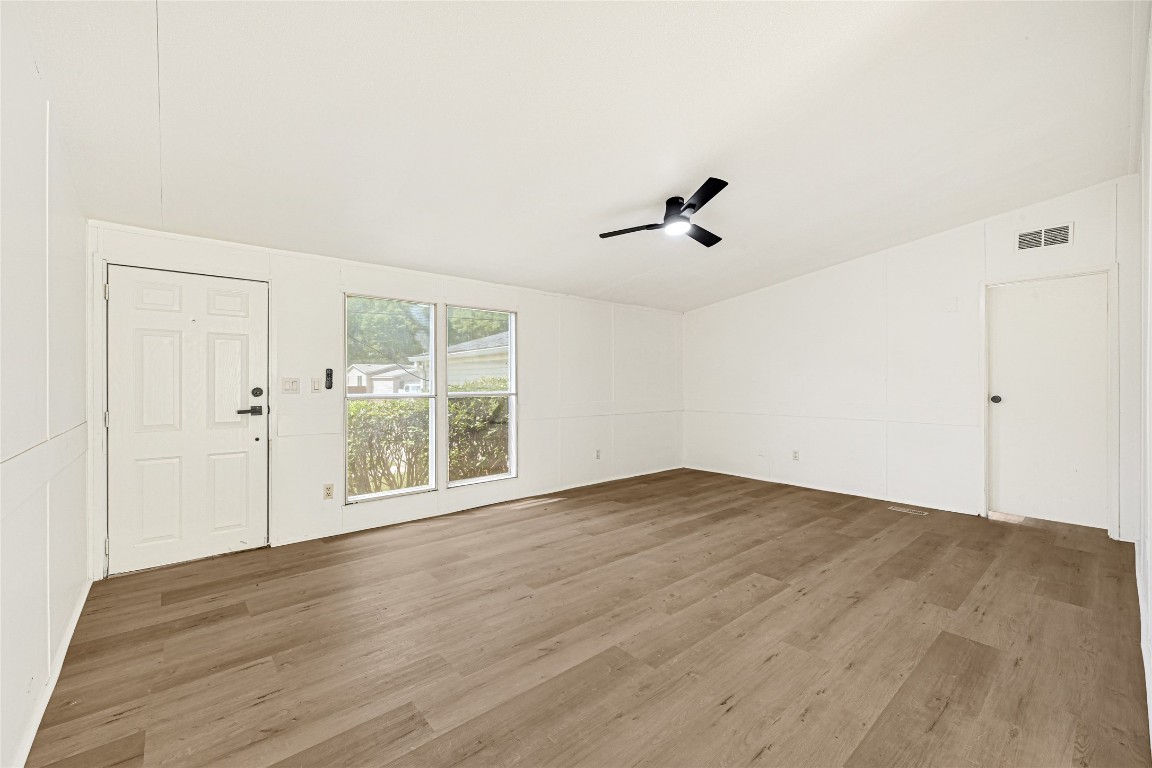 16315 Lone Star Ranch Drive Conroe, TX 77302 - Photo 9 of 20 a view of an empty room with wooden floor and a window