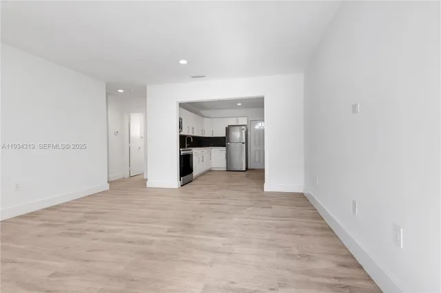 a view of kitchen with wooden floor and electronic appliances