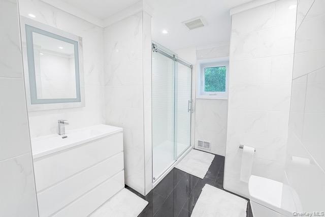 6 Adele Boulevard Spring Valley, NY 10977 - Photo 11 of 16 a bathroom with a sink a toilet a shower and a mirror