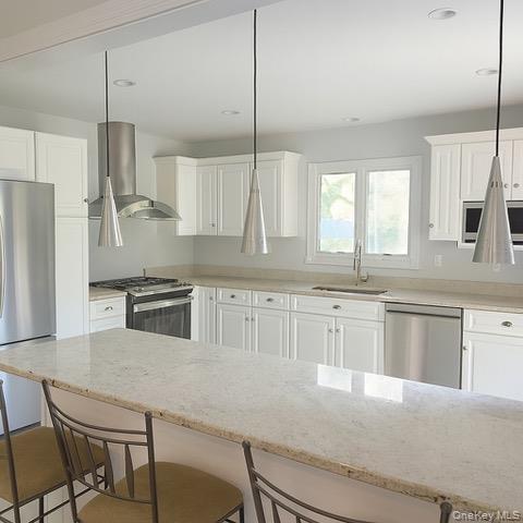 6 Adele Boulevard Spring Valley, NY 10977 - Photo 3 of 16 a kitchen with stainless steel appliances granite countertop a sink a stove a refrigerator a center island and cabinets
