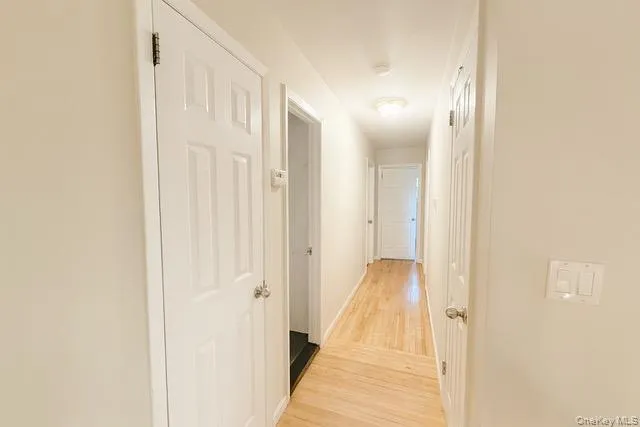 a view of a hallway with wooden floor