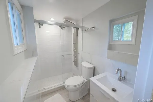 a bathroom with a sink toilet and shower