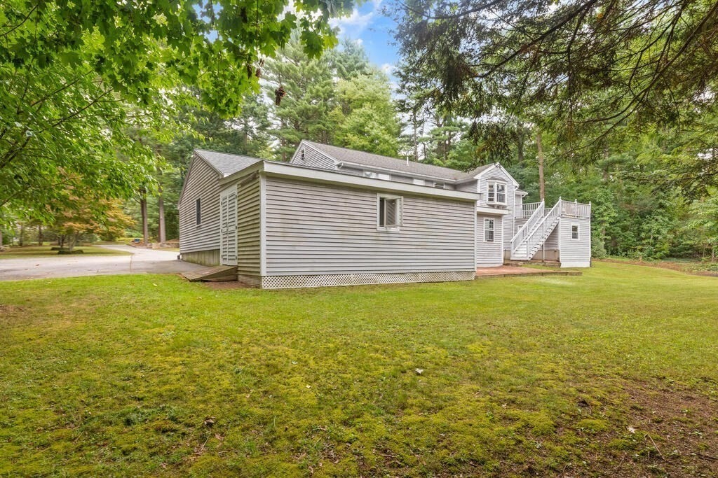 15 1/2 Algonquin Road Canton, MA 02021 - Photo 33 of 37 a view of a backyard with table and chairs and wooden fence