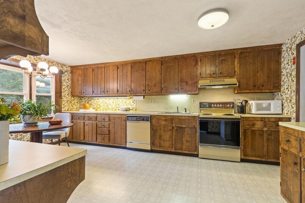 15 1/2 Algonquin Road Canton, MA 02021 - Photo 9 of 37 a kitchen with kitchen island granite countertop a sink cabinets and stainless steel appliances