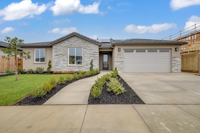 a front view of house with yard and green space