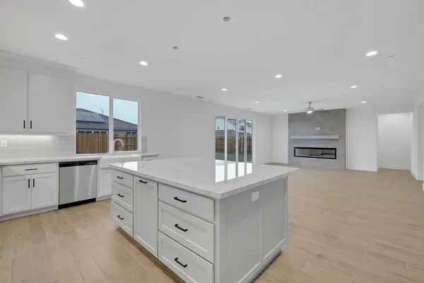 a kitchen with stainless steel appliances granite countertop a stove a sink and a refrigerator