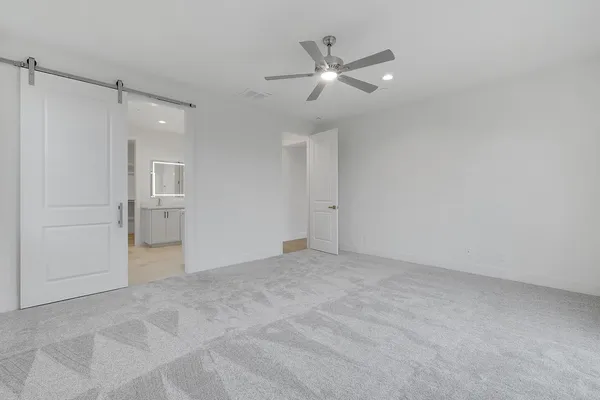 an empty room with fan and entrance