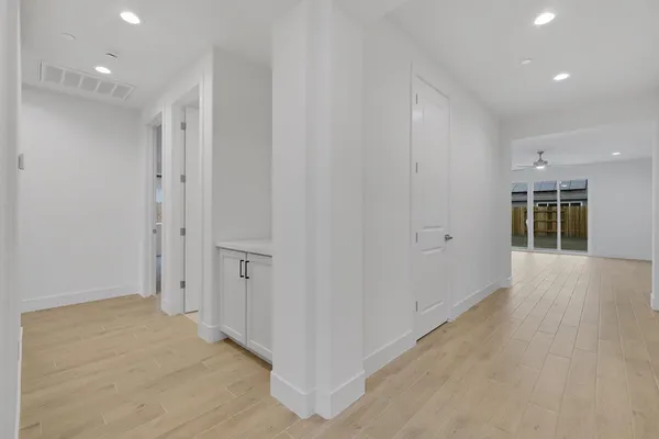 a view of a hallway with wooden floor