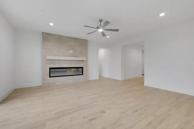 a view of an empty room with a ceiling fan