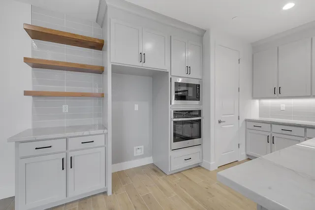 a kitchen with cabinets and window