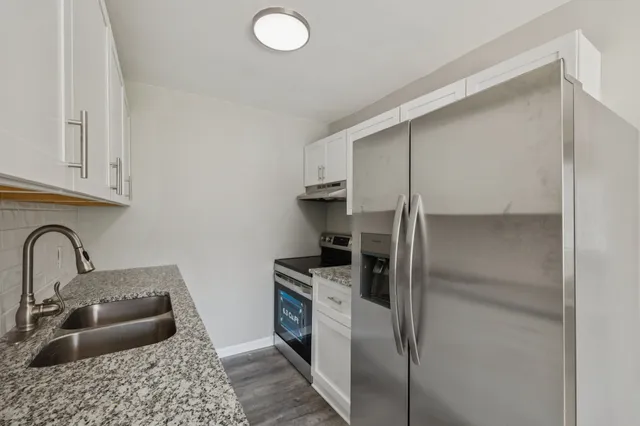 a kitchen with a refrigerator and a sink