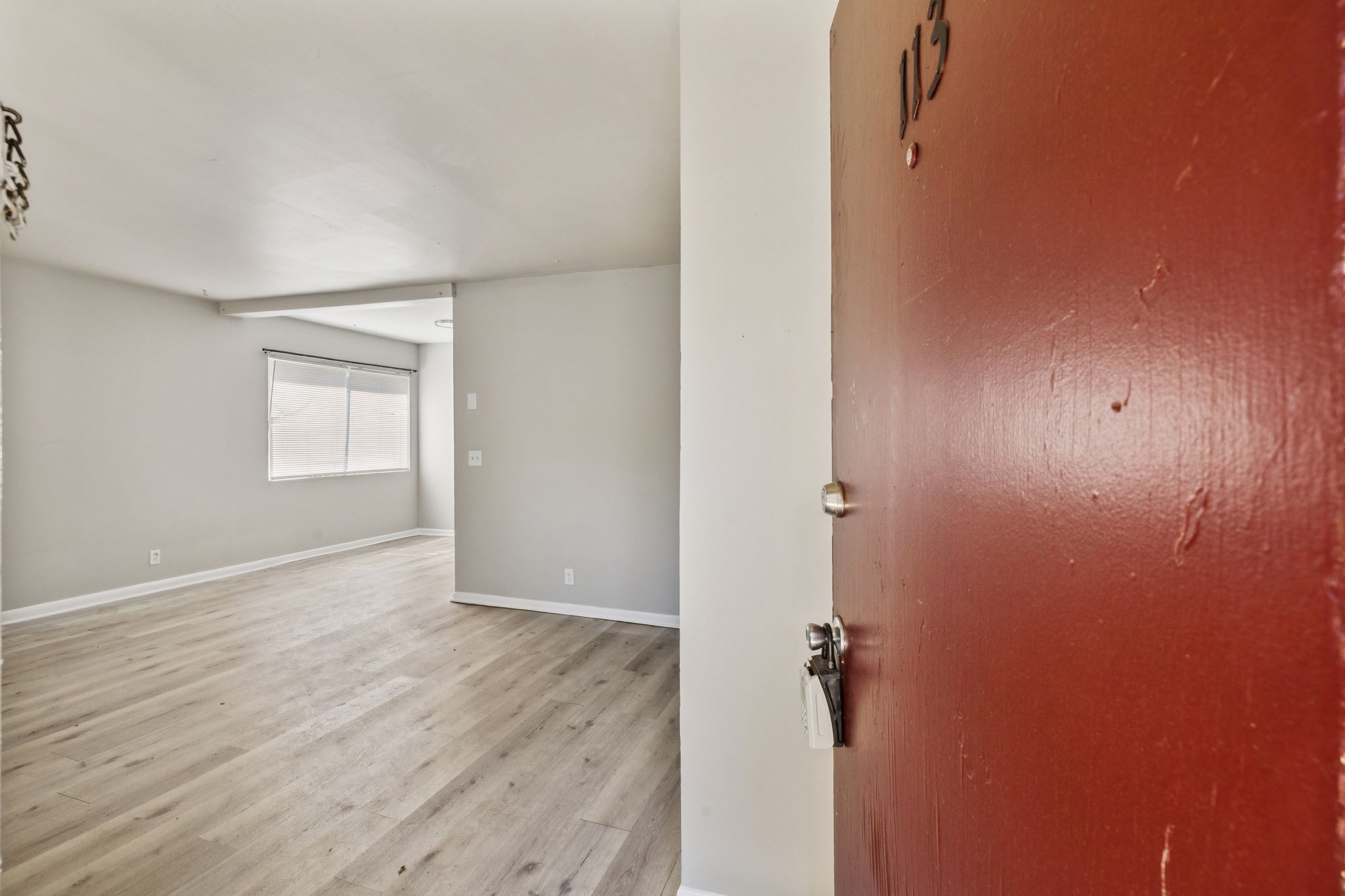 550 Harding Place, Unit D113 Nashville, TN 37211 - Photo 3 of 20 an empty room with wooden floor and windows