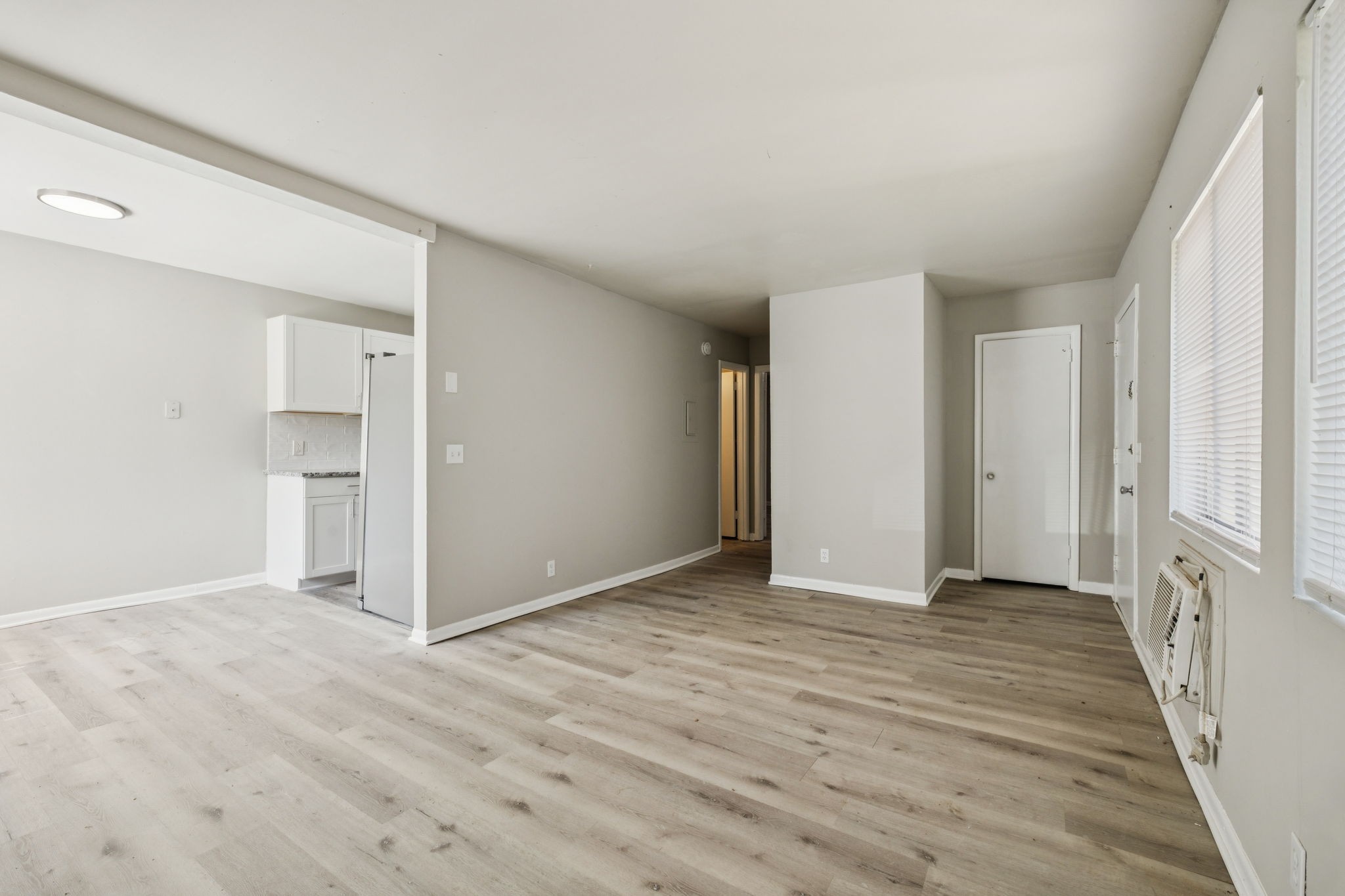 550 Harding Place, Unit D113 Nashville, TN 37211 - Photo 4 of 20 a view of an empty room with wooden floor and a window