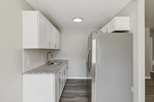 a kitchen with stainless steel appliances granite countertop a refrigerator and a stove