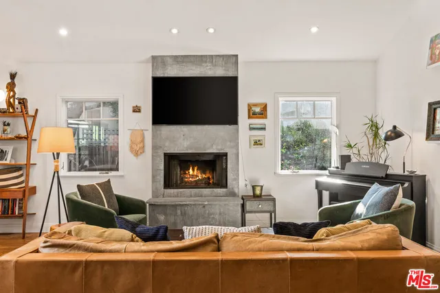 a living room with furniture fireplace and flat screen tv