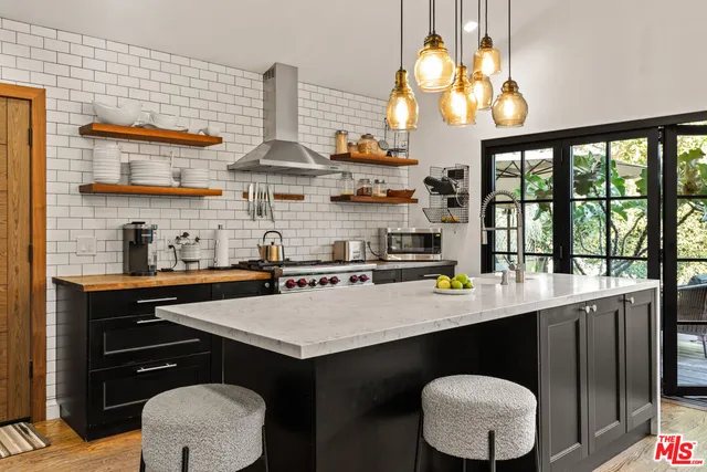 a kitchen with stainless steel appliances a sink and a large window