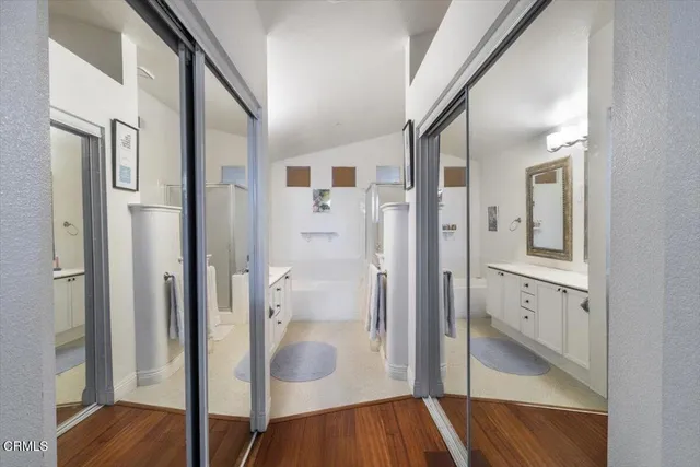 a bathroom with a glass shower door and a sink