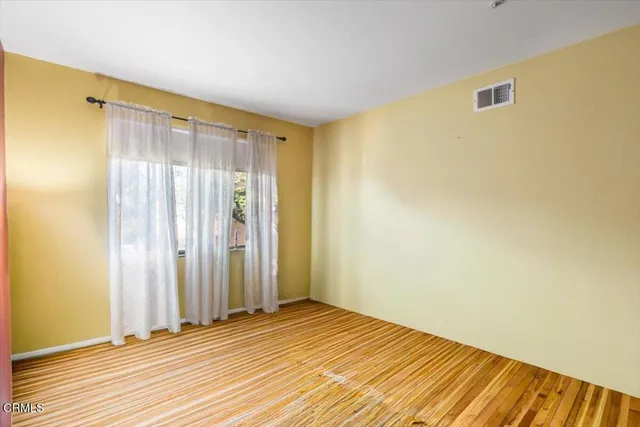 a view of wooden floor and closet in a room