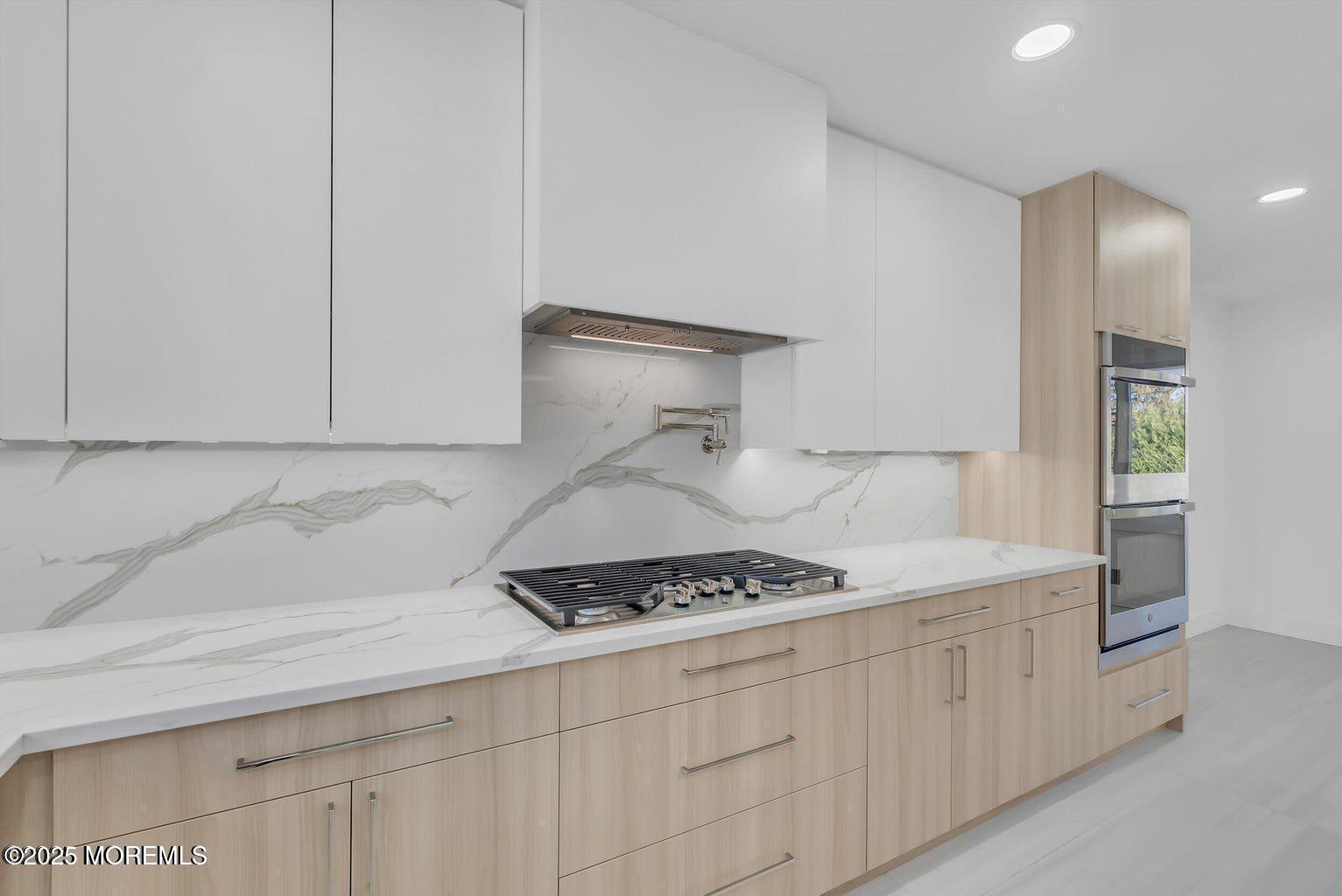 1 Robin Drive Oakhurst, NJ 07755 - Photo 11 of 42 a kitchen with white cabinets and a stove