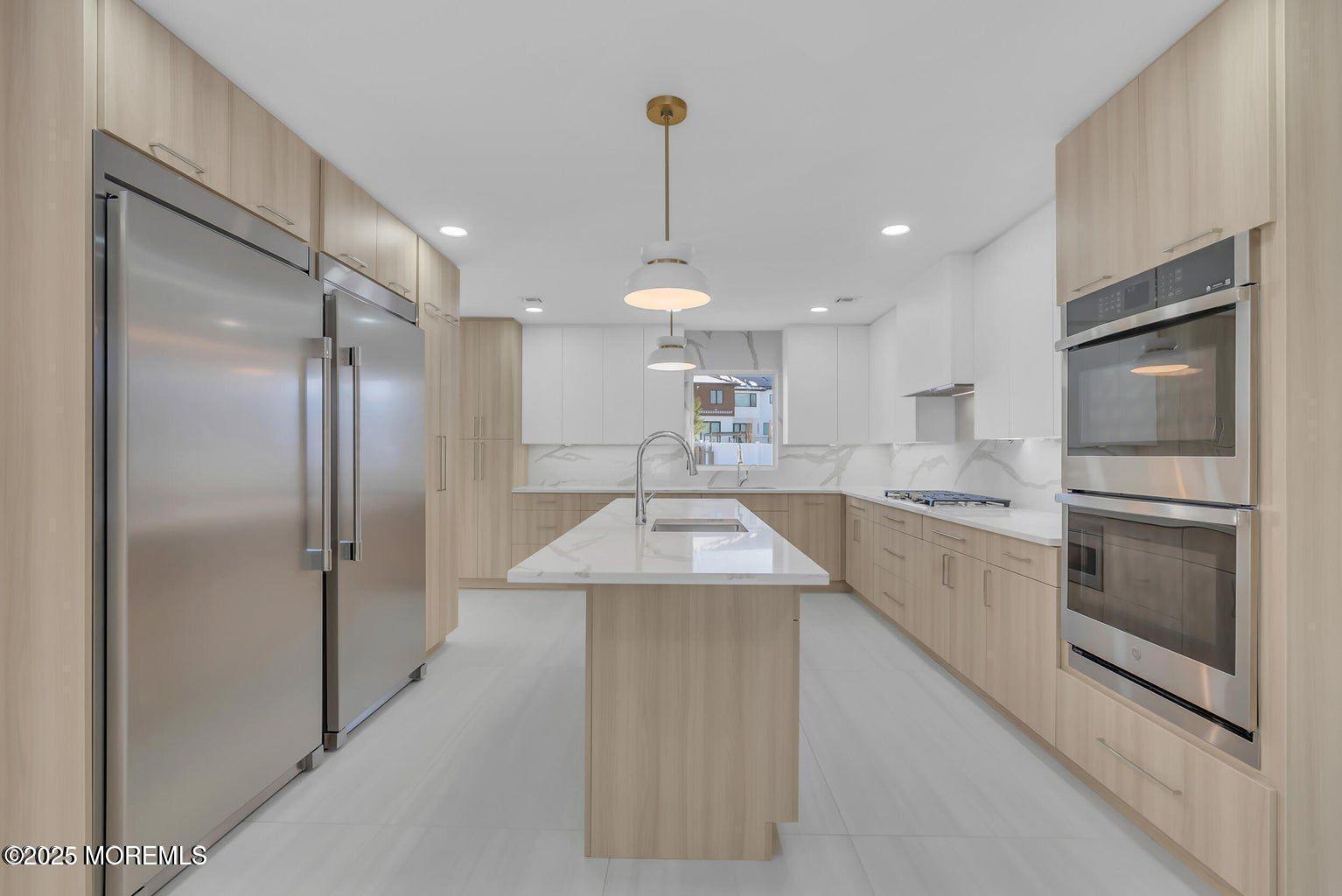 1 Robin Drive Oakhurst, NJ 07755 - Photo 13 of 42 a kitchen with kitchen island a counter top space stainless steel appliances and cabinets