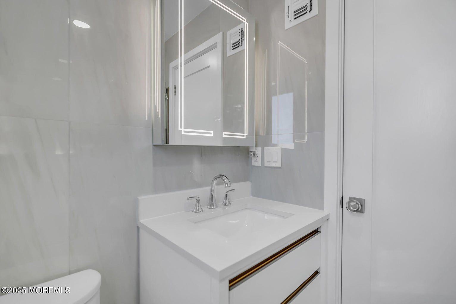 1 Robin Drive Oakhurst, NJ 07755 - Photo 22 of 42 a bathroom with a sink and a toilet