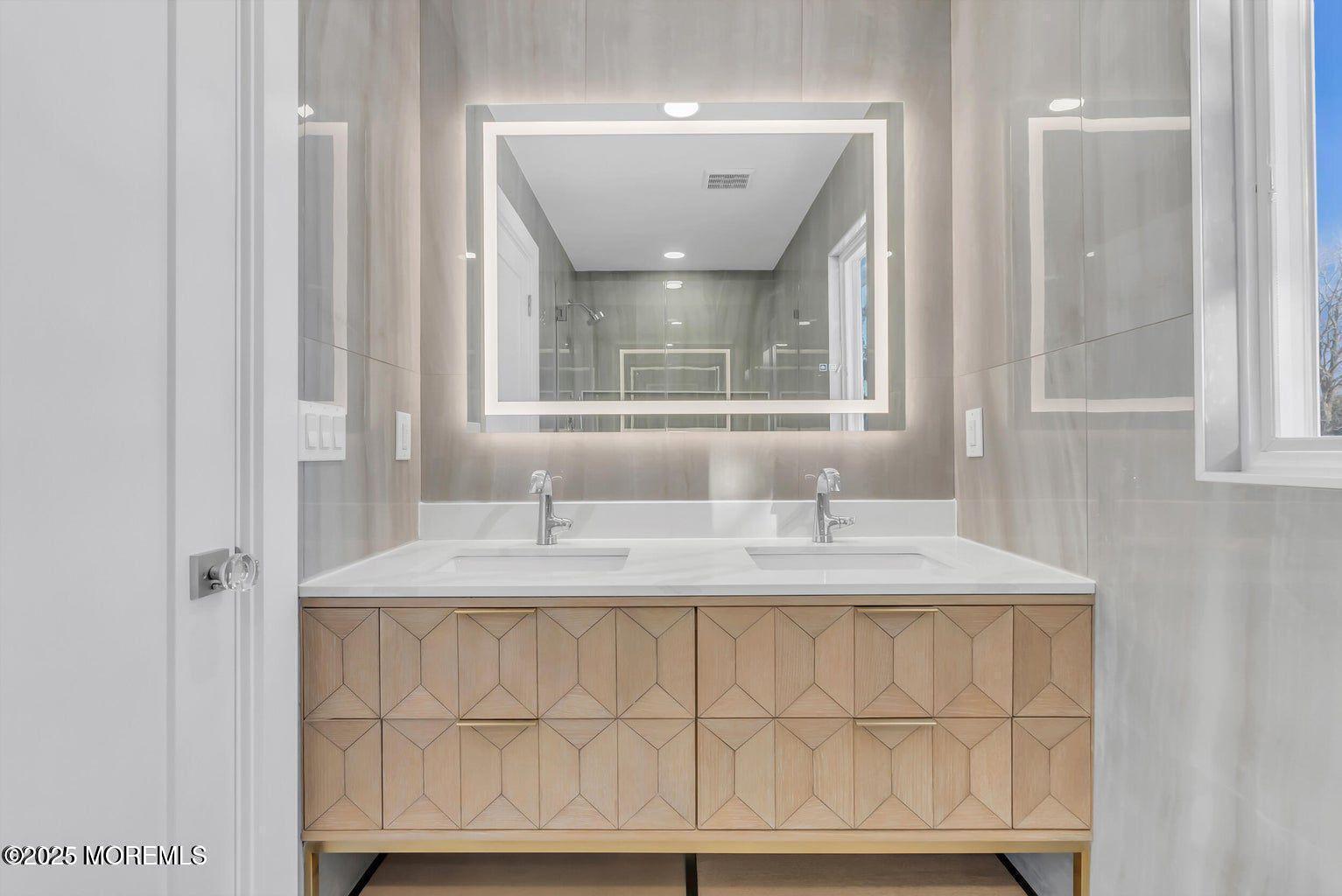 1 Robin Drive Oakhurst, NJ 07755 - Photo 29 of 42 a bathroom with a sink and a mirror