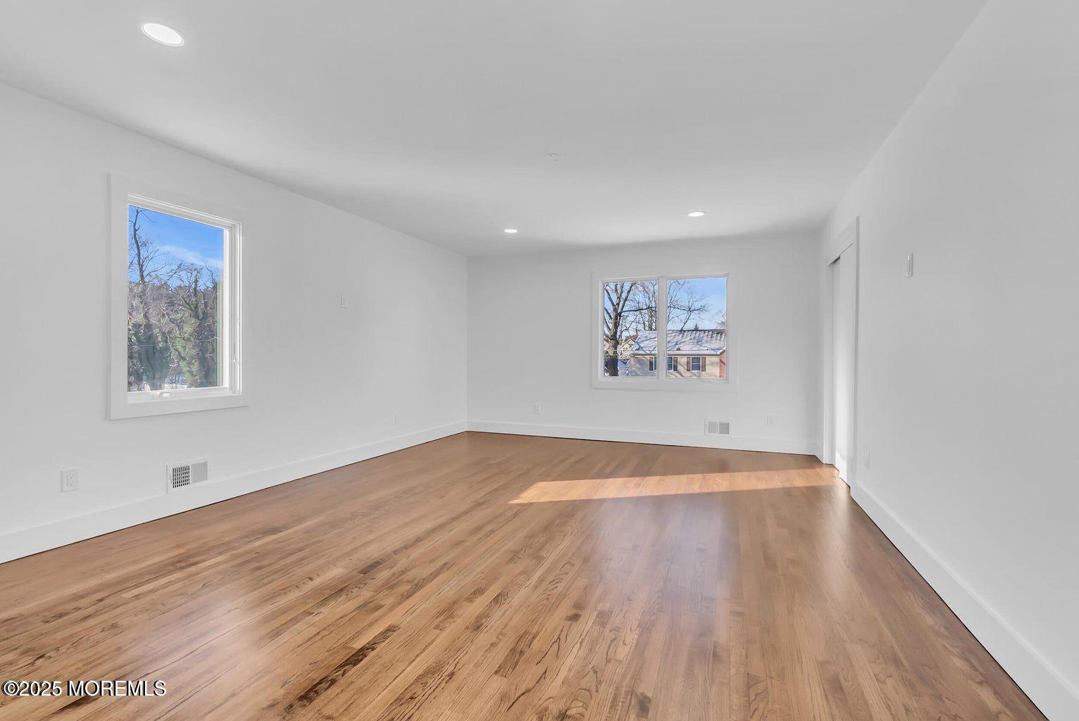 1 Robin Drive Oakhurst, NJ 07755 - Photo 36 of 42 a view of an empty room with wooden floor and a window