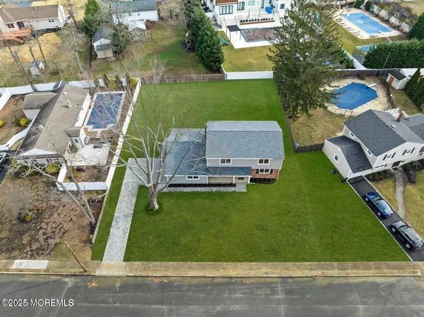 a view of yard with swimming pool and green space
