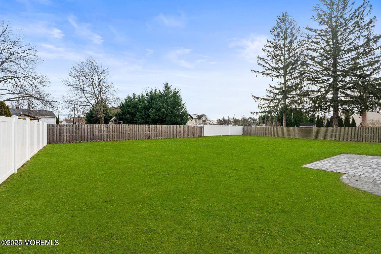 1 Robin Drive Oakhurst, NJ 07755 - Photo 4 of 42 a view of yard with grass and trees