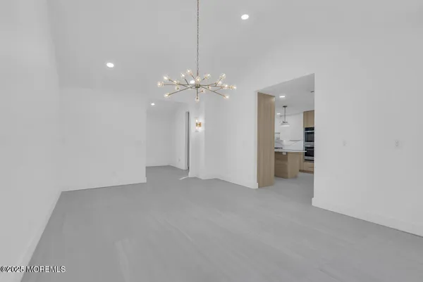a view of a chandelier in big room and chandelier fan