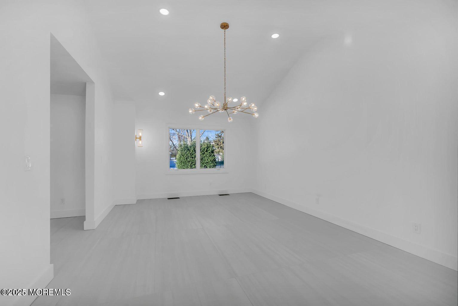 1 Robin Drive Oakhurst, NJ 07755 - Photo 8 of 42 a view of a chandelier in big room and chandelier fan