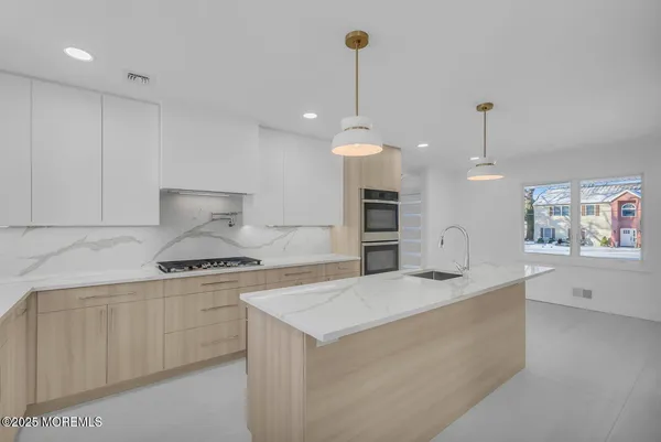 a kitchen with white cabinets and a stove