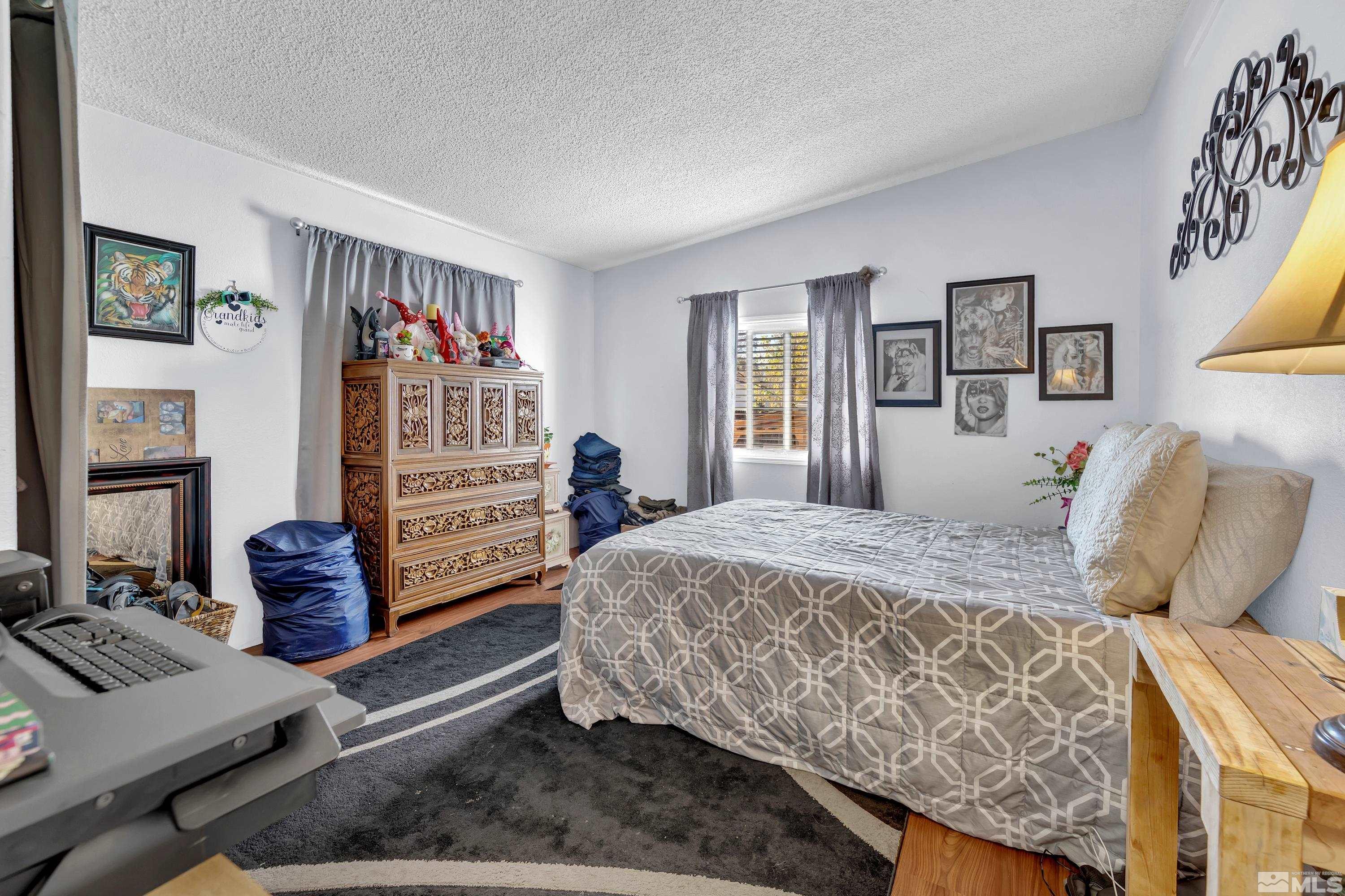 1536 King Lane Reno, NV 89521 - Photo 19 of 31 a bedroom with a bed and a window
