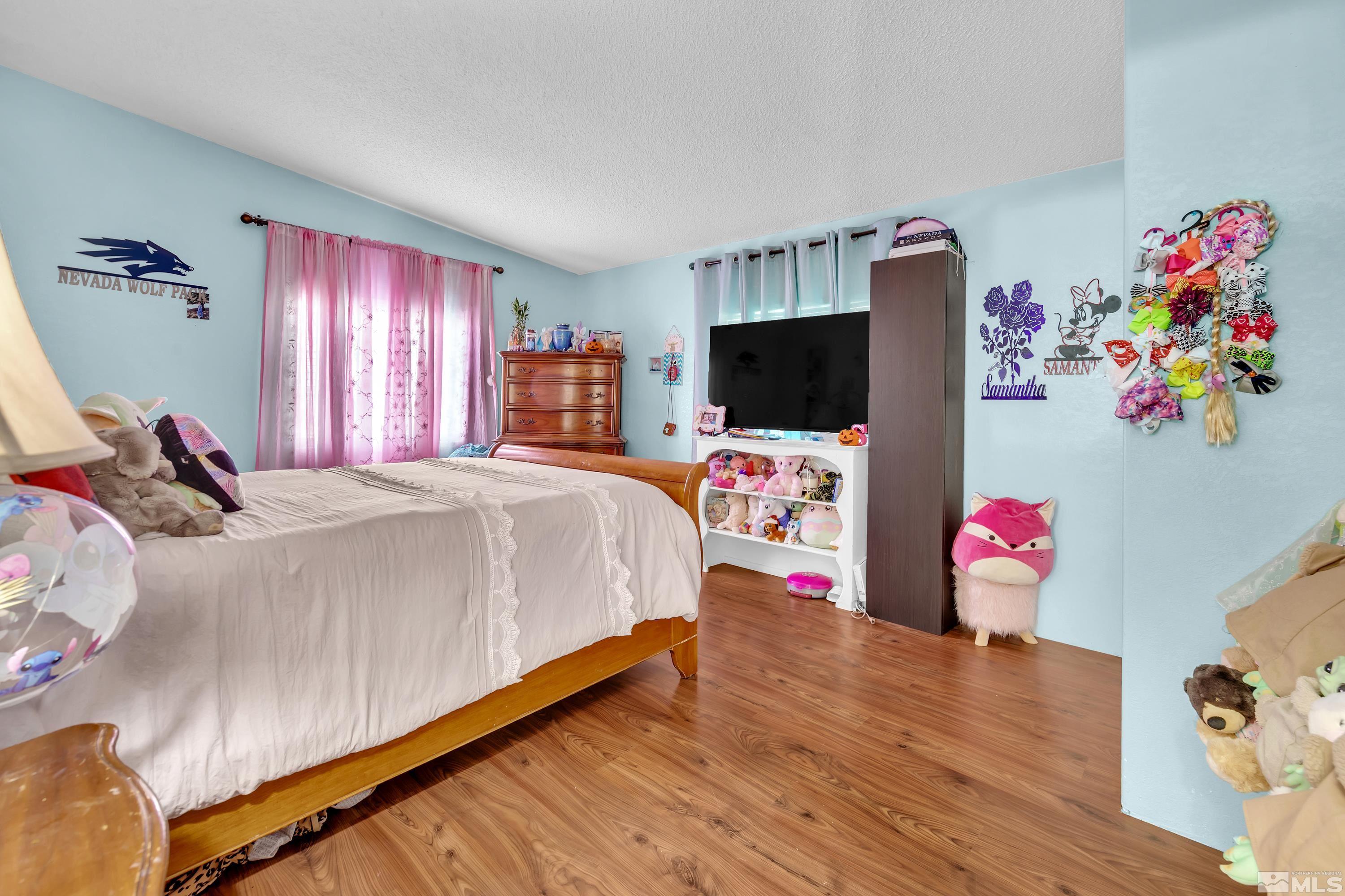 1536 King Lane Reno, NV 89521 - Photo 20 of 31 a bedroom with a bed and a flat screen tv
