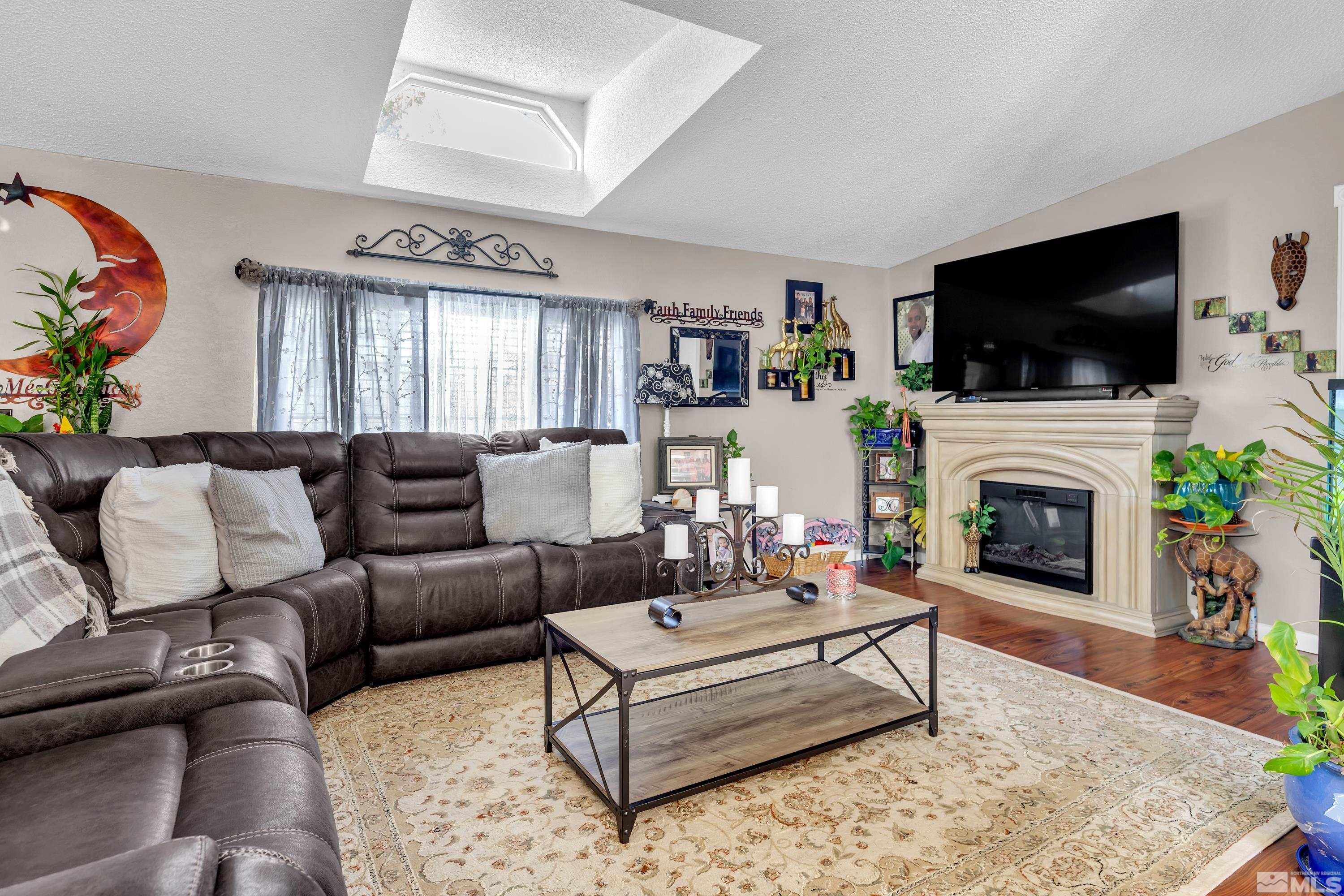 1536 King Lane Reno, NV 89521 - Photo 7 of 31 a living room with furniture a flat screen tv and a fireplace
