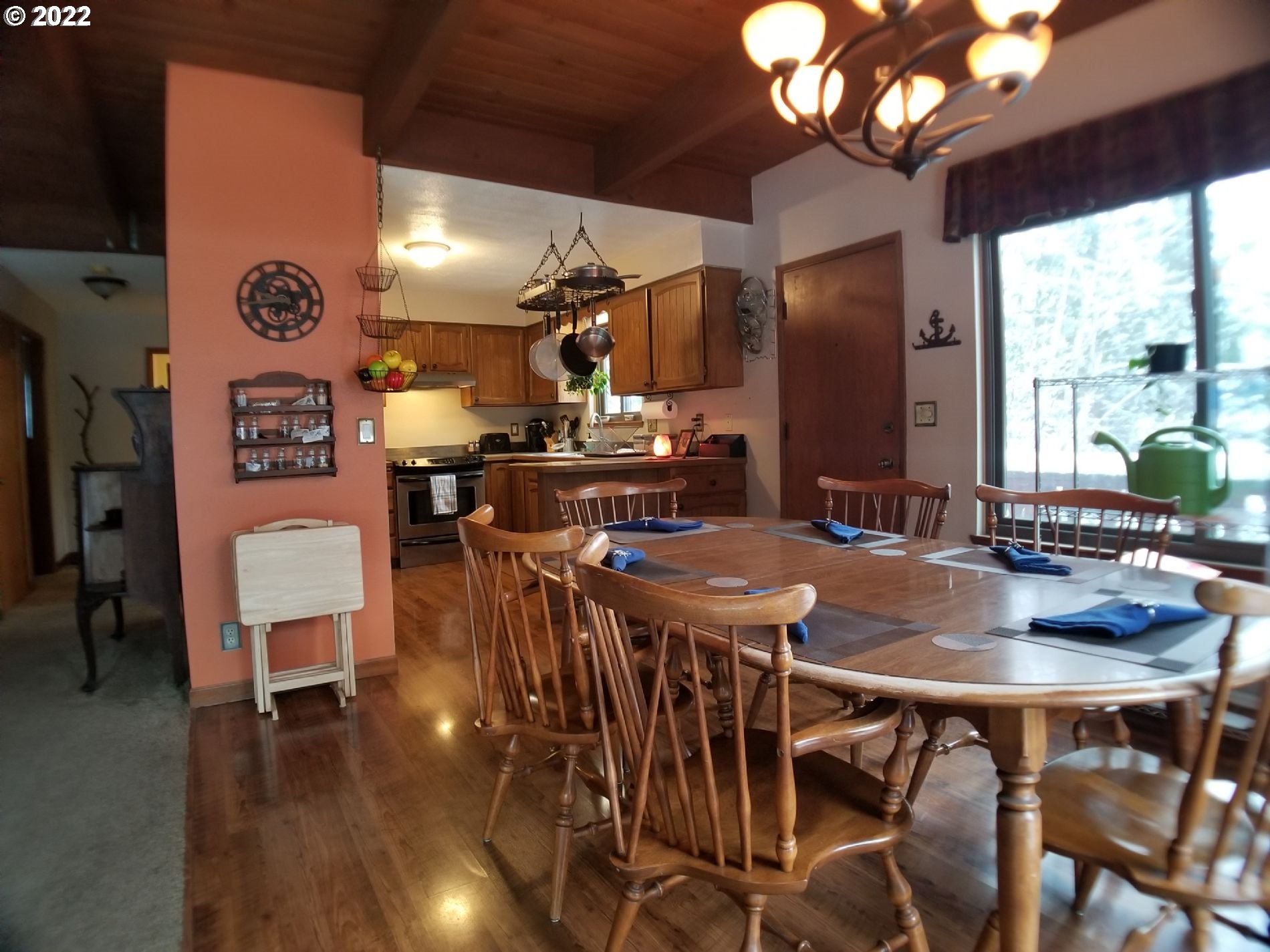 21545 Hideway Lane Rhododendron, OR 97049 - Photo 5 of 6 a view of a dining room with furniture wooden floor and chandelier