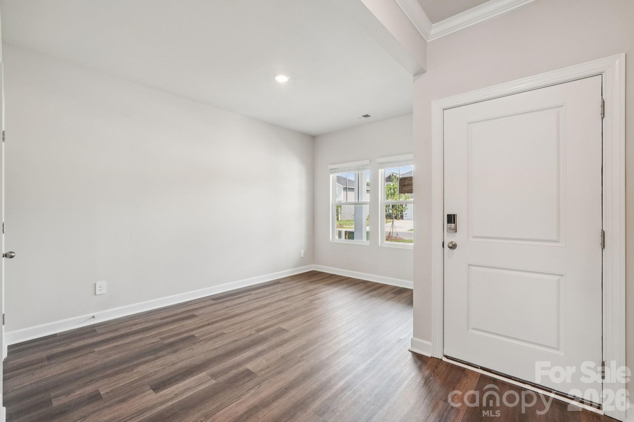 2452 Chartwell Street Stanley, NC 28164 - Photo 8 of 15 wooden floor in an empty room with a window