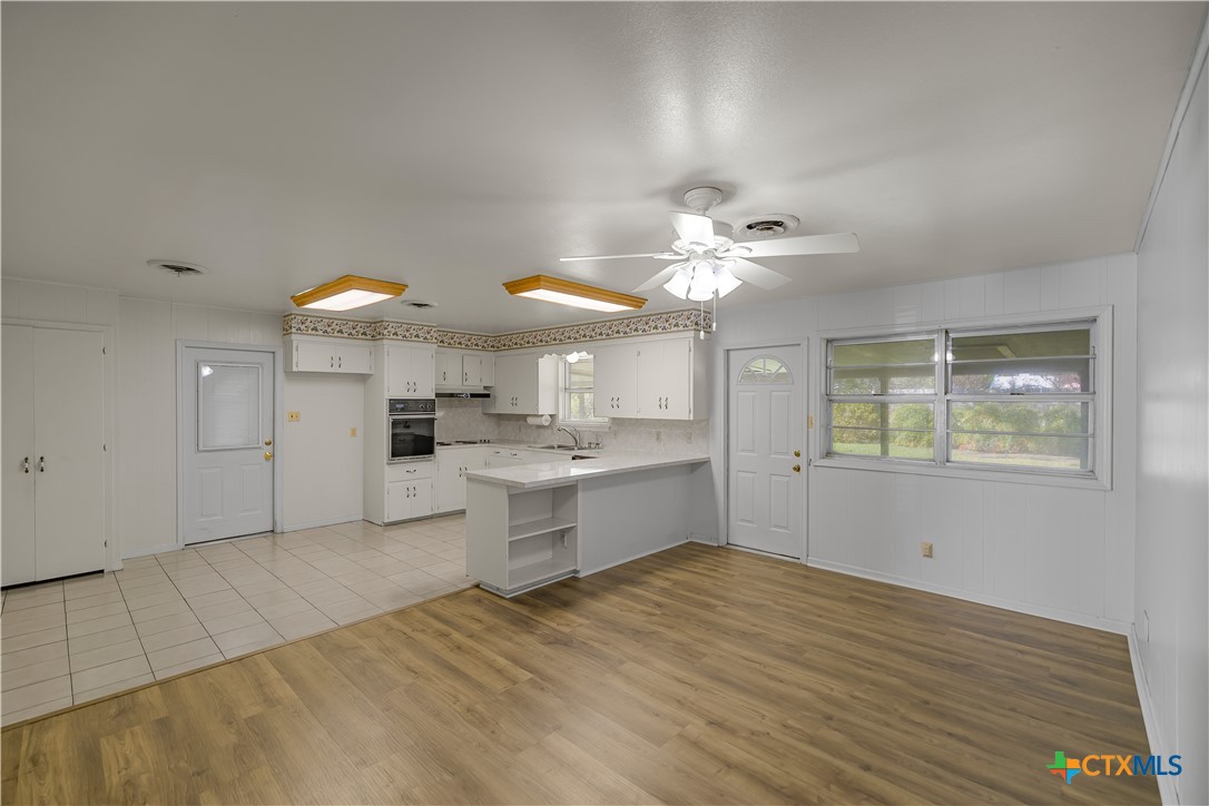 3104 Erwin Avenue Victoria, TX 77901 - Photo 4 of 19 a view of a kitchen with kitchen island a sink stainless steel appliances and cabinets