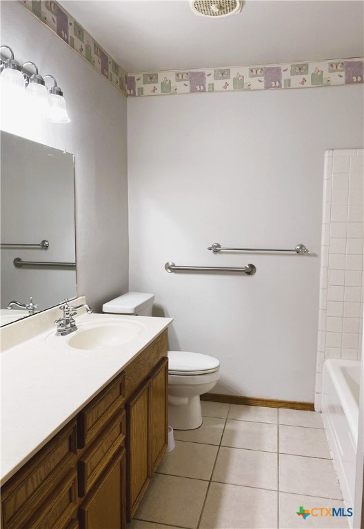 3104 Erwin Avenue Victoria, TX 77901 - Photo 9 of 19 a bathroom with a sink a toilet and vanity