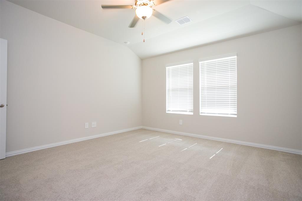 404 Castle Road Sherman, TX 75092 - Photo 9 of 25 an empty room with a window and a ceiling fan