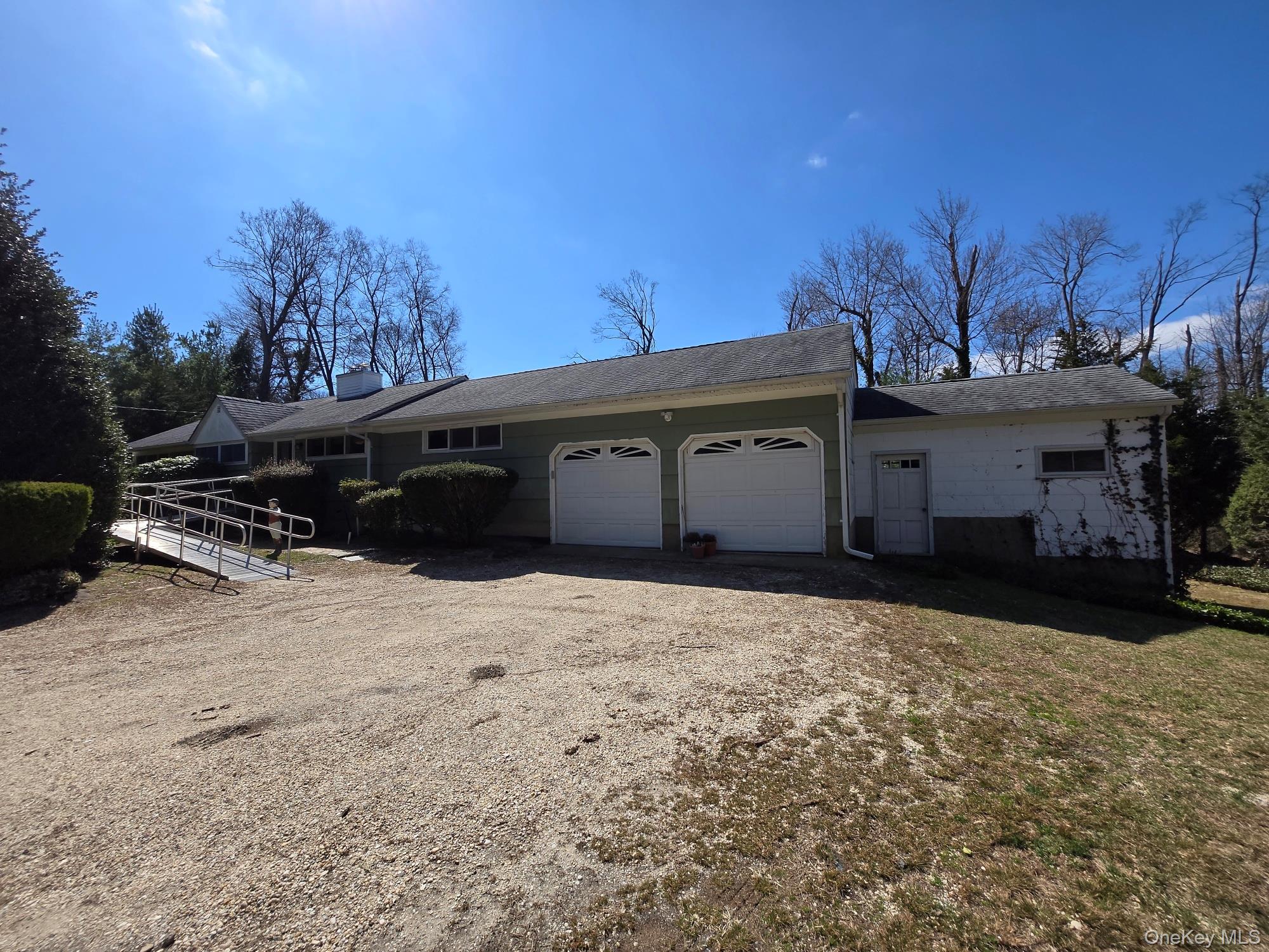 858 Fort Salonga Road Northport, NY 11768 - Photo 1 of 12 a front view of a house with a yard and garage