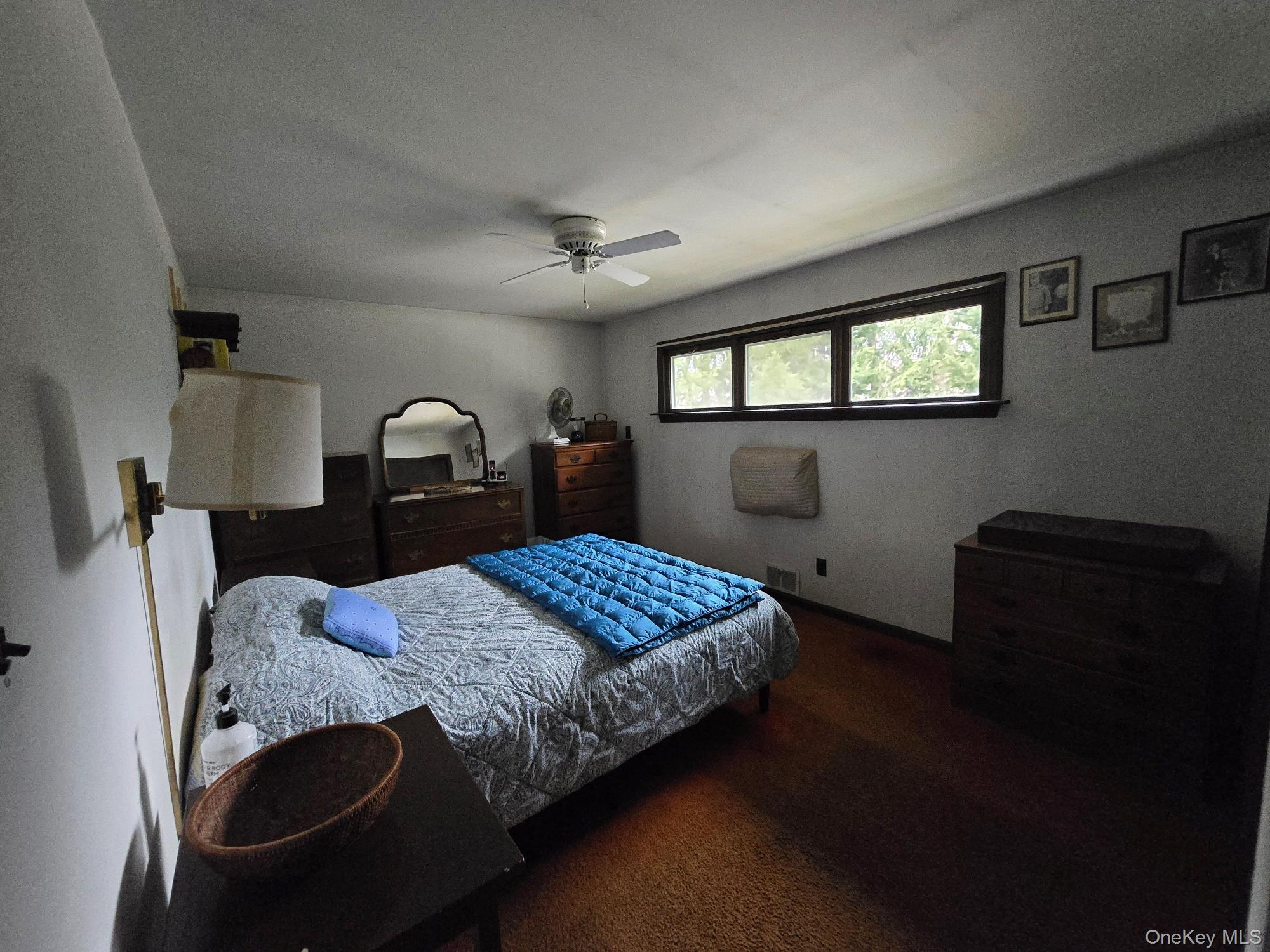 858 Fort Salonga Road Northport, NY 11768 - Photo 3 of 12 a bedroom with a bed and a dresser