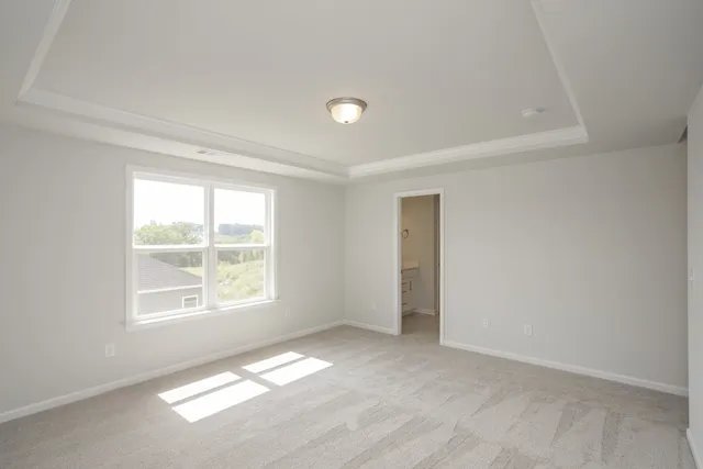 a bedroom with a bed a mirror and a large window