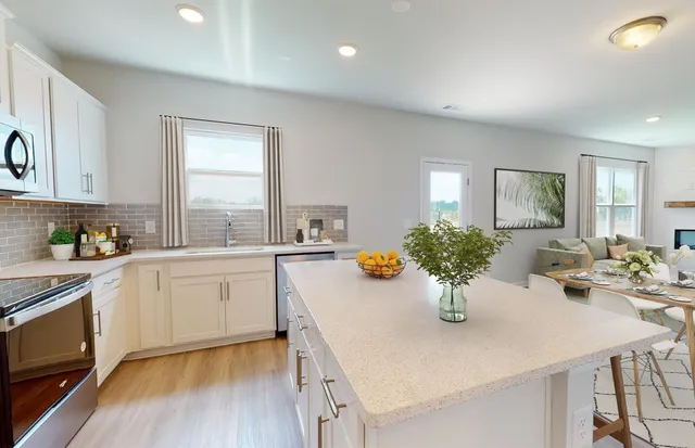 a kitchen with a white table and chairs