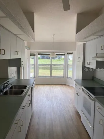 a kitchen that has a sink and cabinets in it