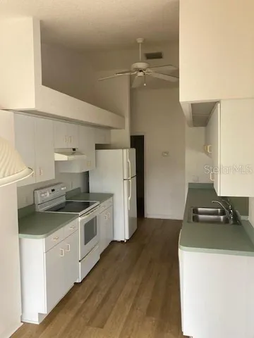 a kitchen with a stove and a refrigerator
